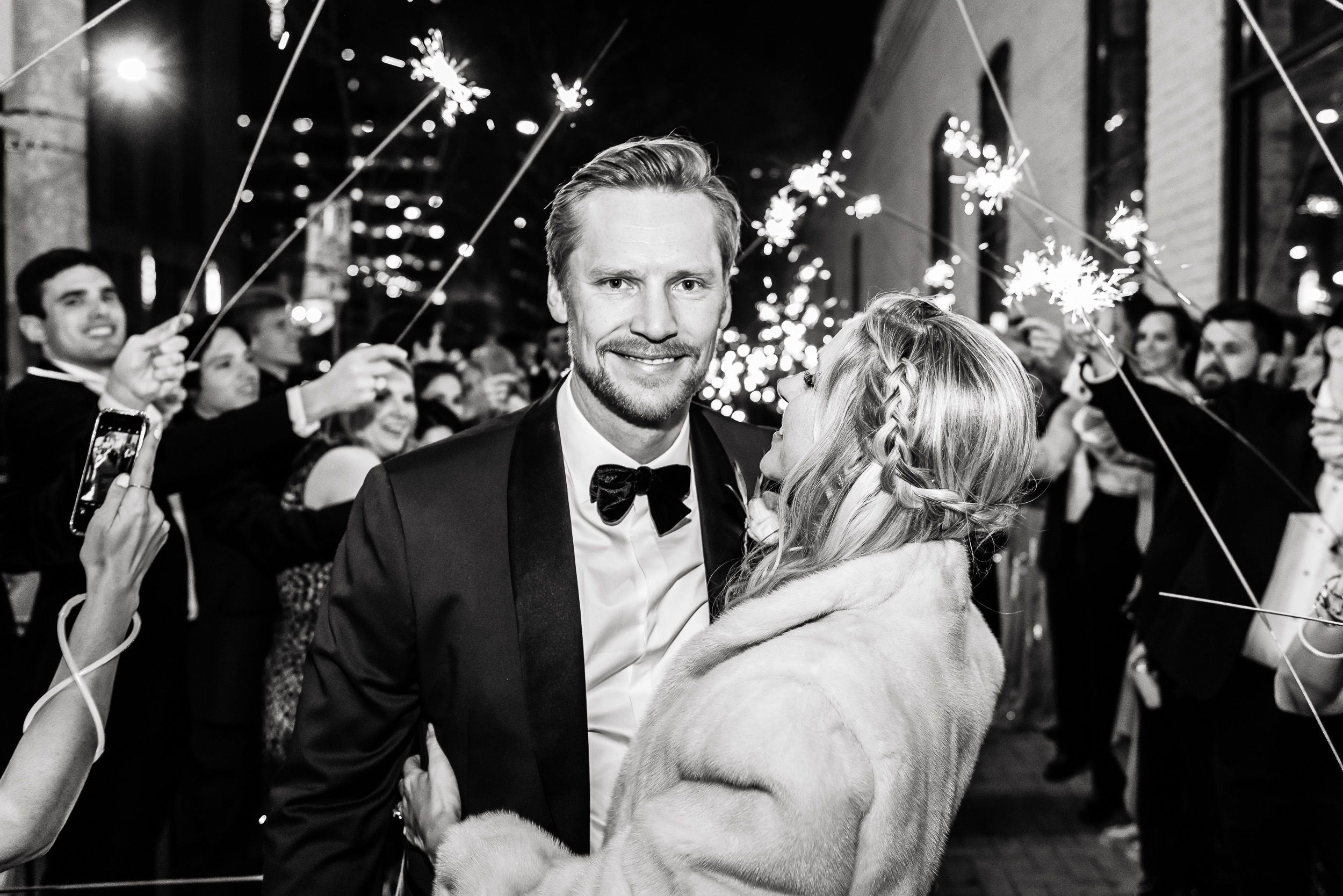 Austin-wedding-photographers-brazos-hall-downtown-exit-sparklers-sidewalk-fur-jacket-tuxedo