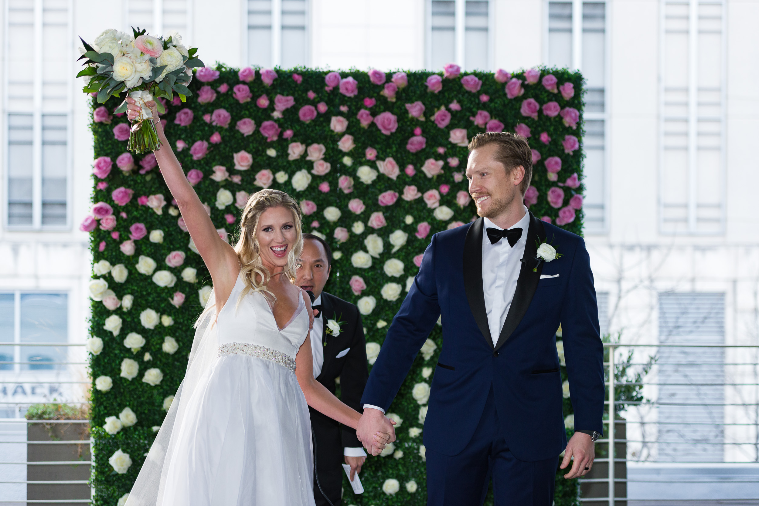 Austin-wedding-photographers-brazos-hall-downtown-married-excited-flower-wall-roses