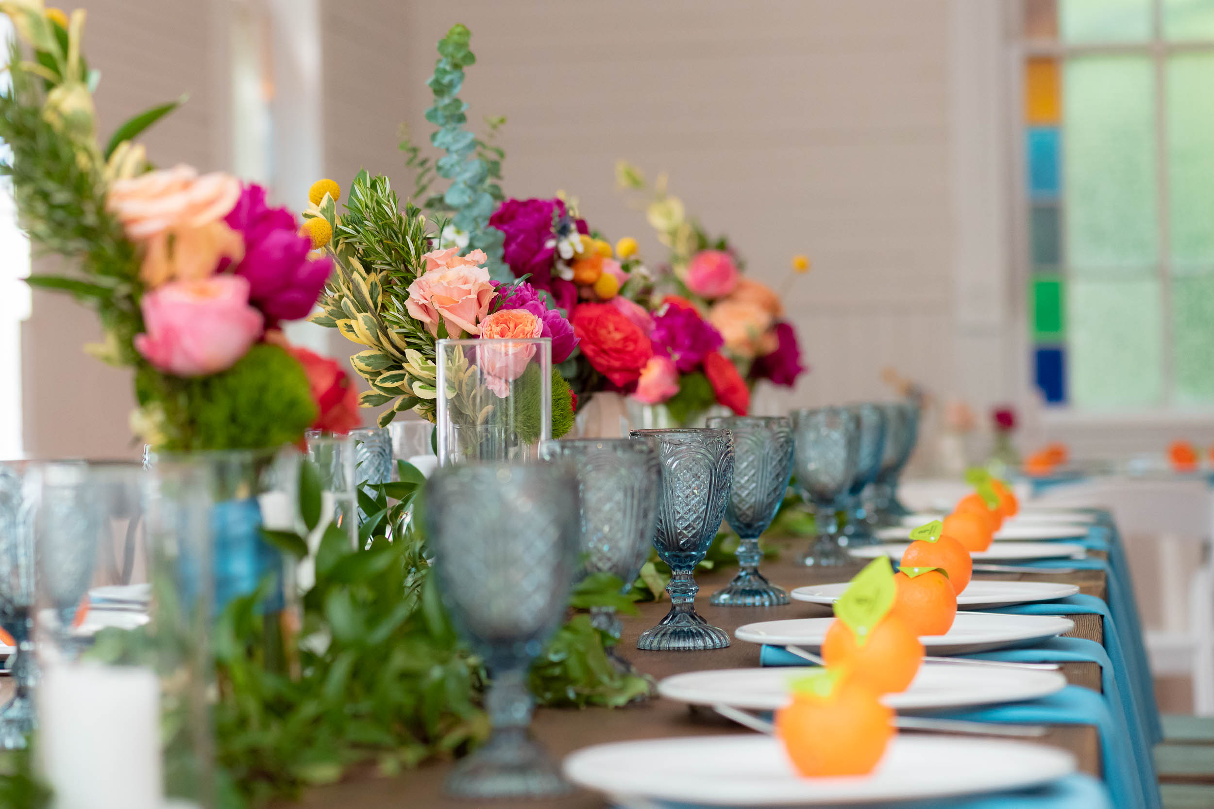 Mercury-Hall-Austin-Wedding-Photographers-texas-flowers-table-setting-blue-glasses-oranges