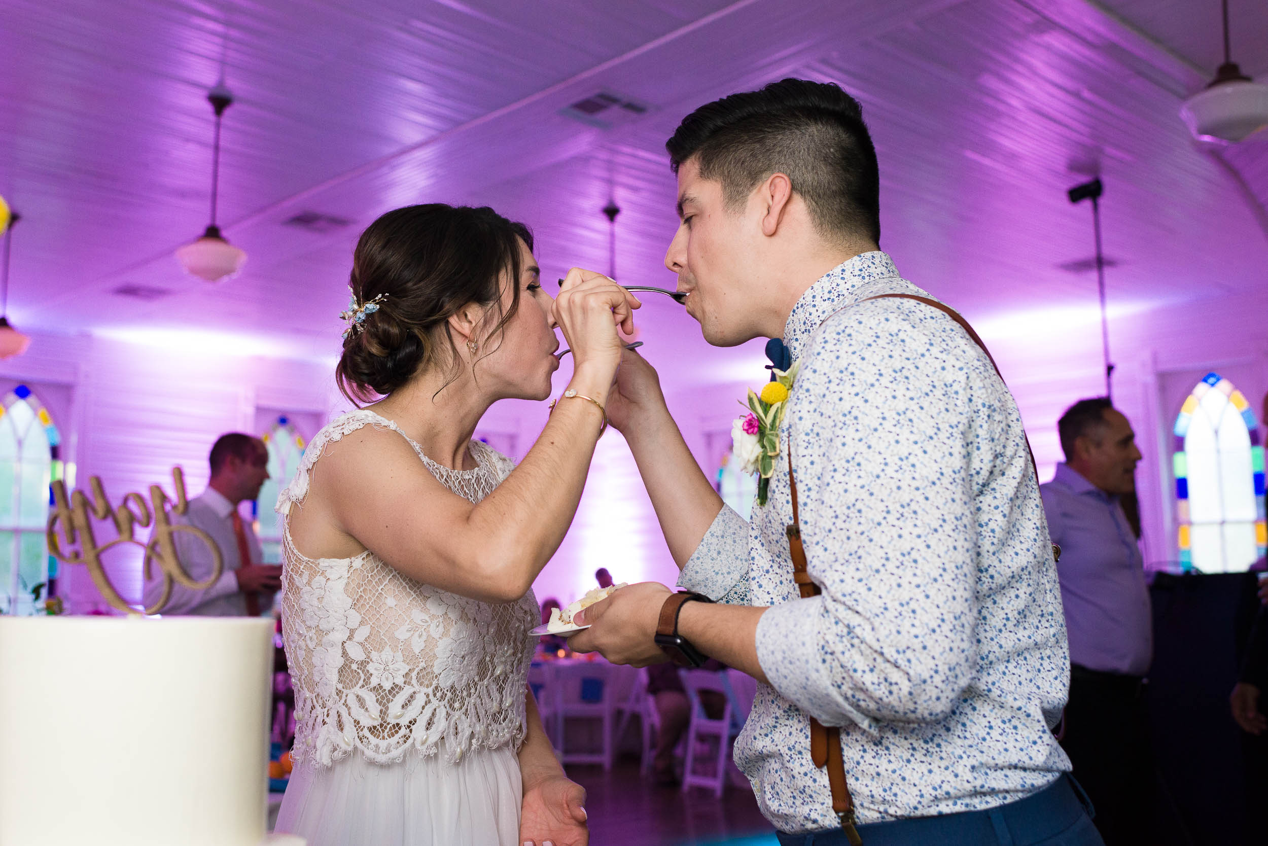Reception-Austin-Wedding-Photographers-cake-cutting-groom-bride-Mercury-Hall