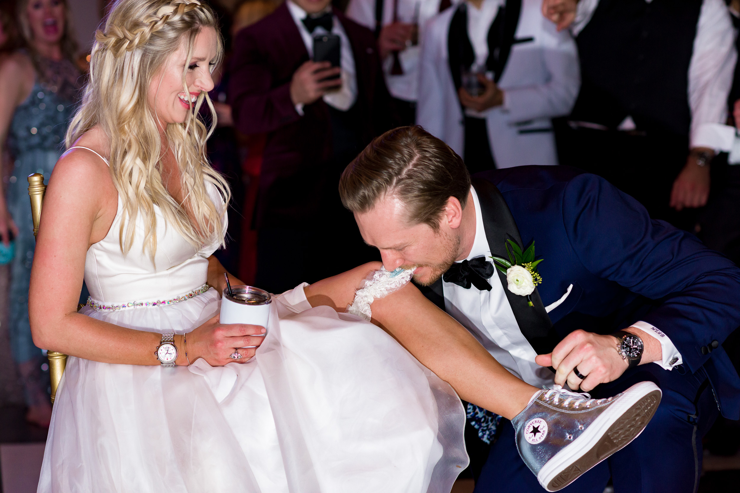 bride-converse-shoes-dress-garter-groom-Austin-wedding-photographers-brazos-hall-downtown