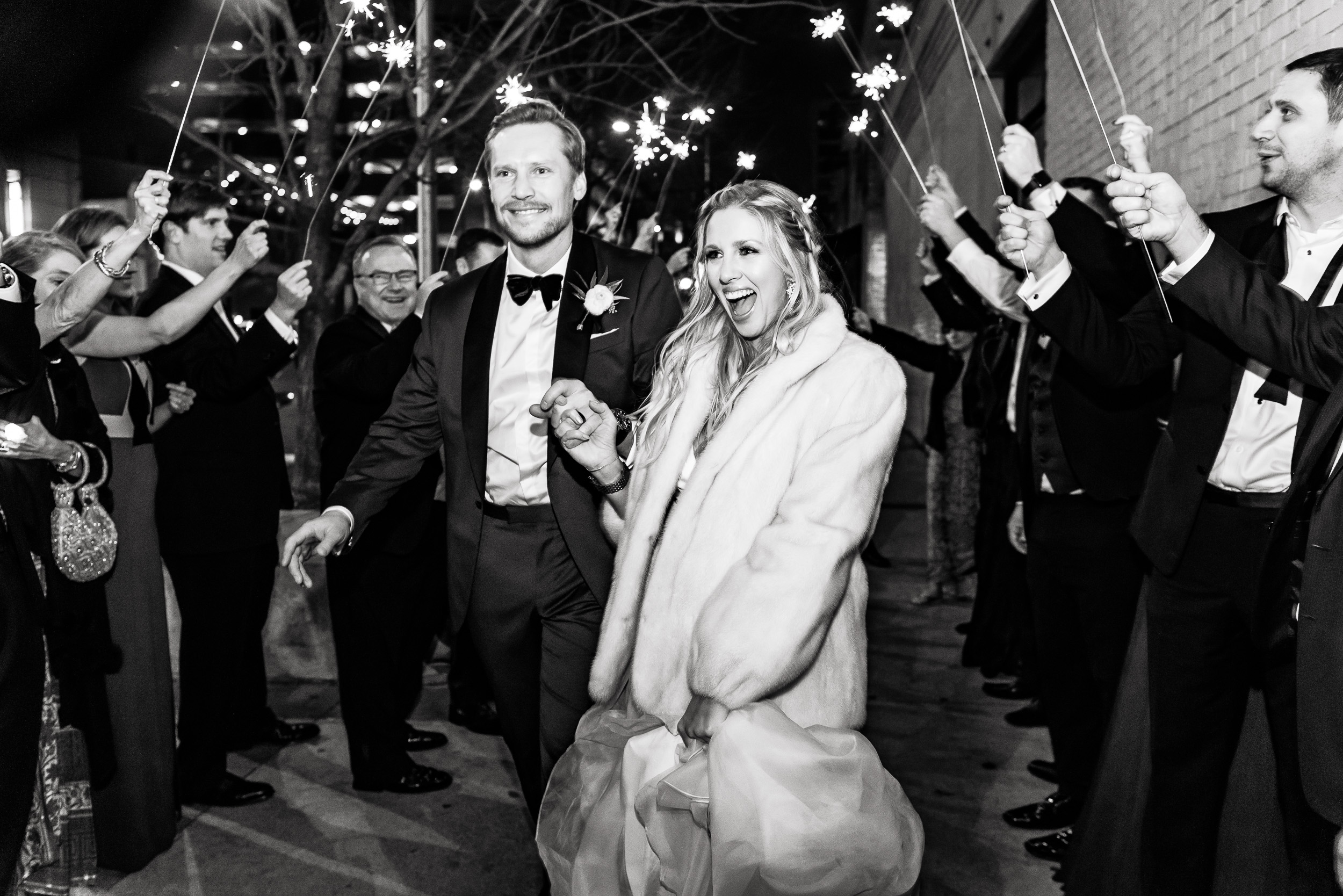 sparkler-exit-fur-tuxedo-winter-Austin-wedding-photographers-brazos-hall-downtown